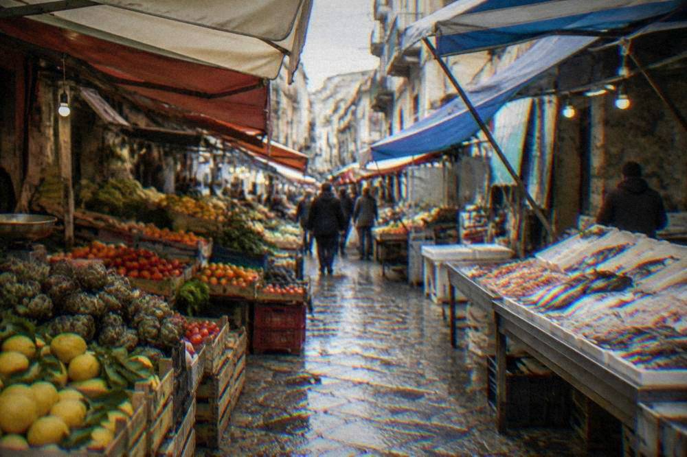 A narrow street market lane in Palermo with canvas awnings and stalls of produce and fish