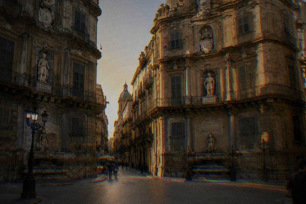 Sunlit baroque facades meeting at the Quattro Canti crossroads in Palermo