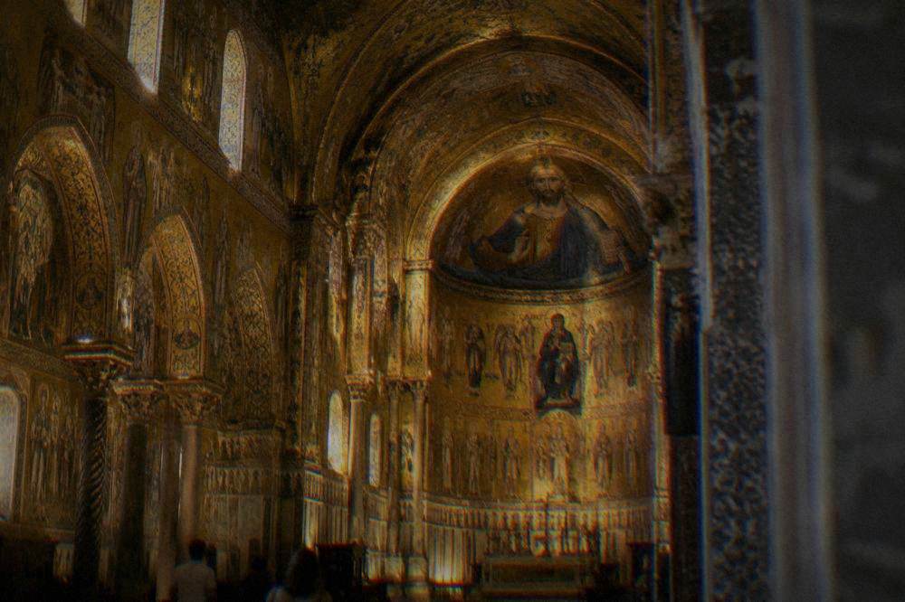 A golden mosaic interior glowing inside a Palermo chapel