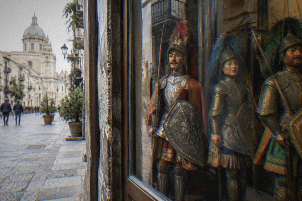 Handcrafted Sicilian puppet marionettes displayed in a workshop window