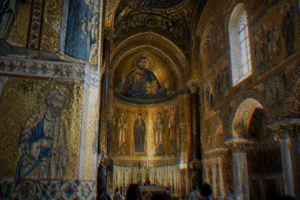 A gilded chapel interior with mosaic decoration on walls and ceiling