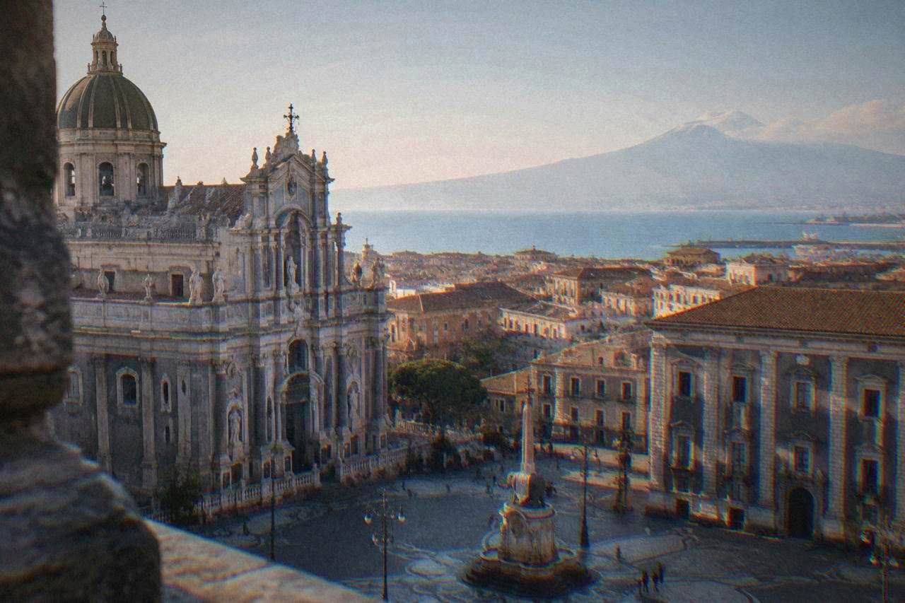View over Palermo rooftops toward the Tyrrhenian Sea with mountains in the distance