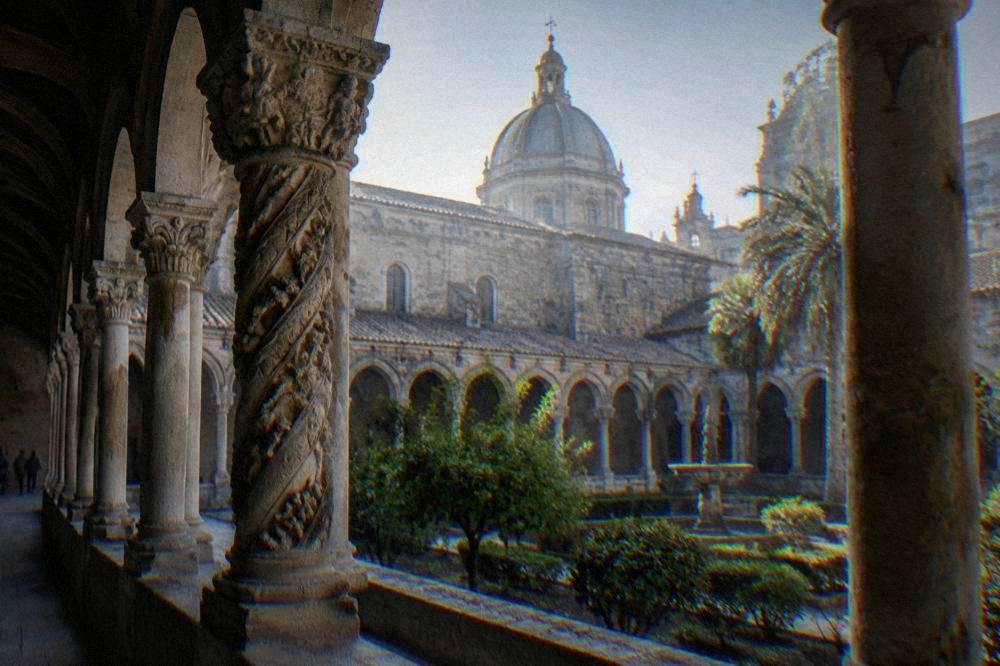 Cloister arches of a Sicilian cathedral courtyard with carved columns
