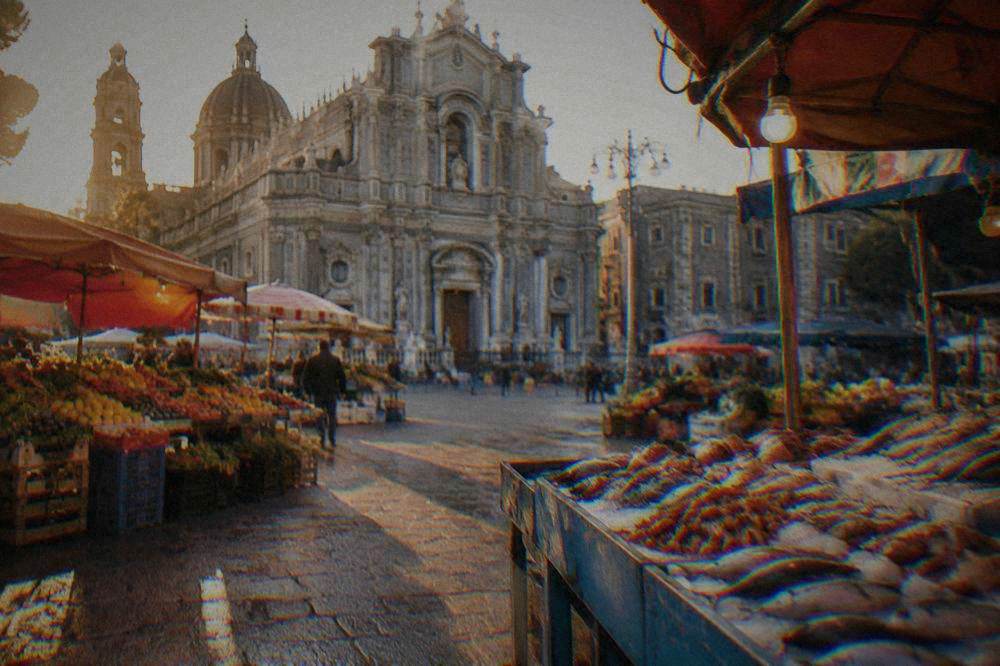 Brightly painted market stalls with fruit, vegetables and fresh fish on a Palermo street