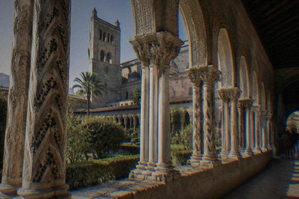 Cloister arches with carved columns at the Monreale cloister in sunlight
