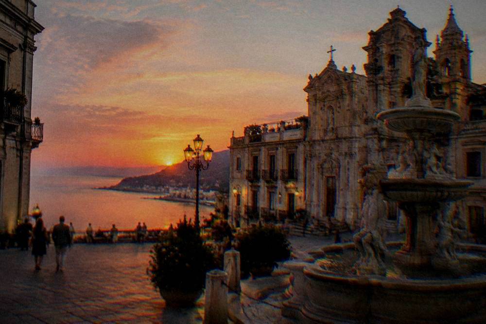Evening light on a baroque square with fountain and ornate facades in Palermo