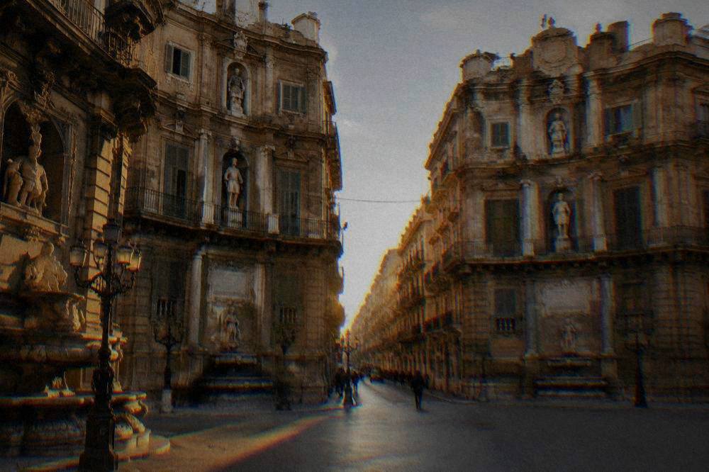 The ornate corner buildings of the Quattro Canti square in Palermo seen from street level