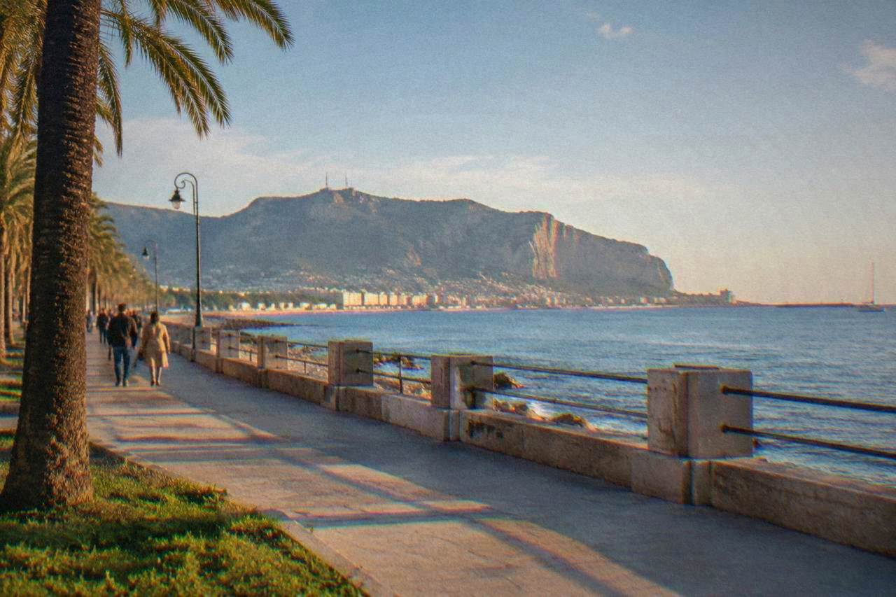 The Palermo seafront under a bright sky with calm water along the Gulf of Palermo