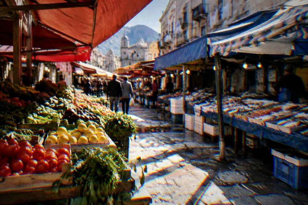 Colourful market stalls under awnings in a Palermo street market
