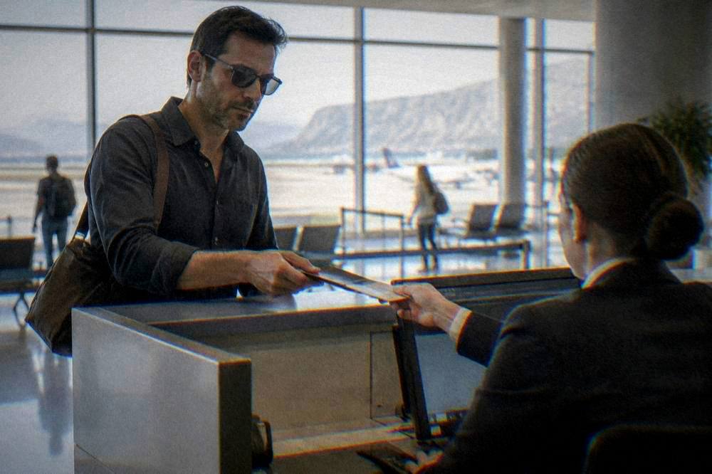 A driver handing documents across a car rental desk at an airport counter