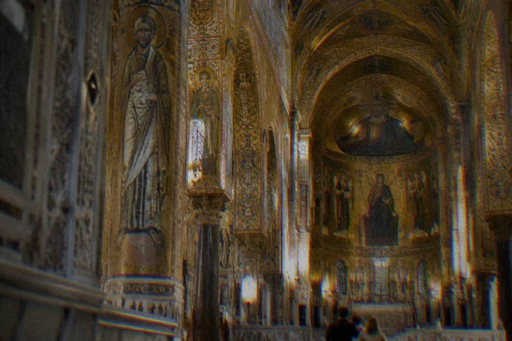 The ornate interior of the Palatine Chapel with gold mosaic decoration on every wall