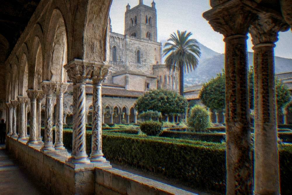 Twinned arches of the Monreale cloister with a garden courtyard in the centre