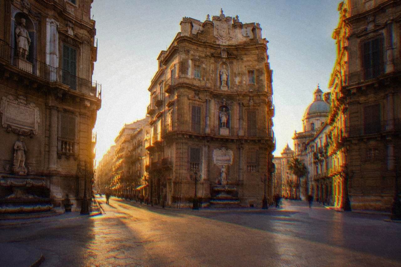 The four corner facades of the Quattro Canti intersection in Palermo at golden hour