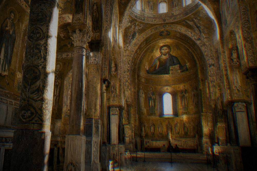 The ornate interior of the Palatine Chapel with gold mosaics on every wall