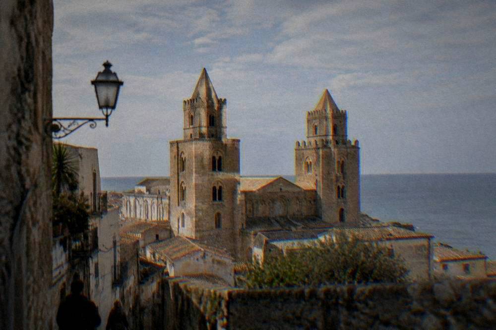Cefalu cathedral towers seen from the old town towards the sea
